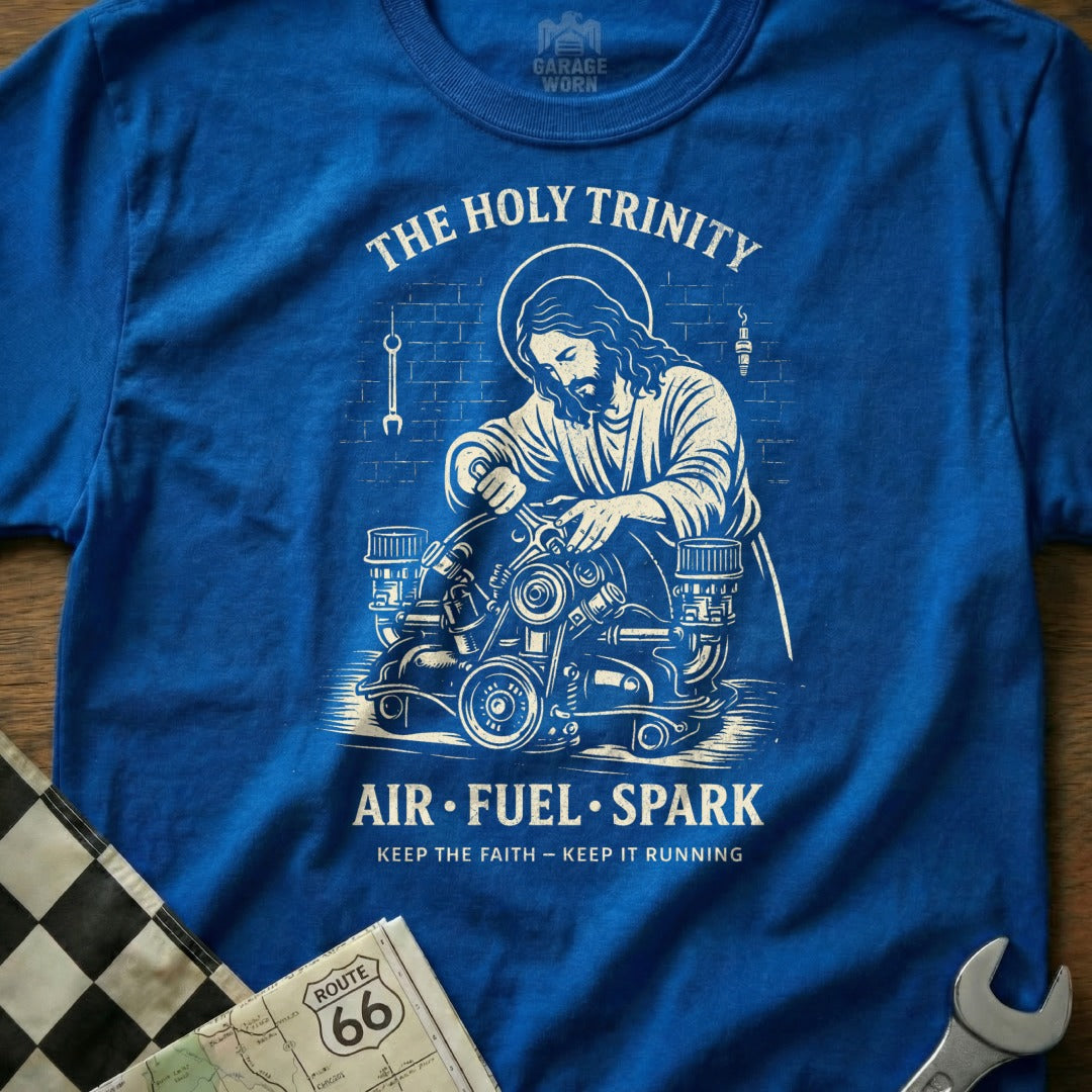 Jesus working on an engine, with text "The Holy Trinity Air Fuel Spark".