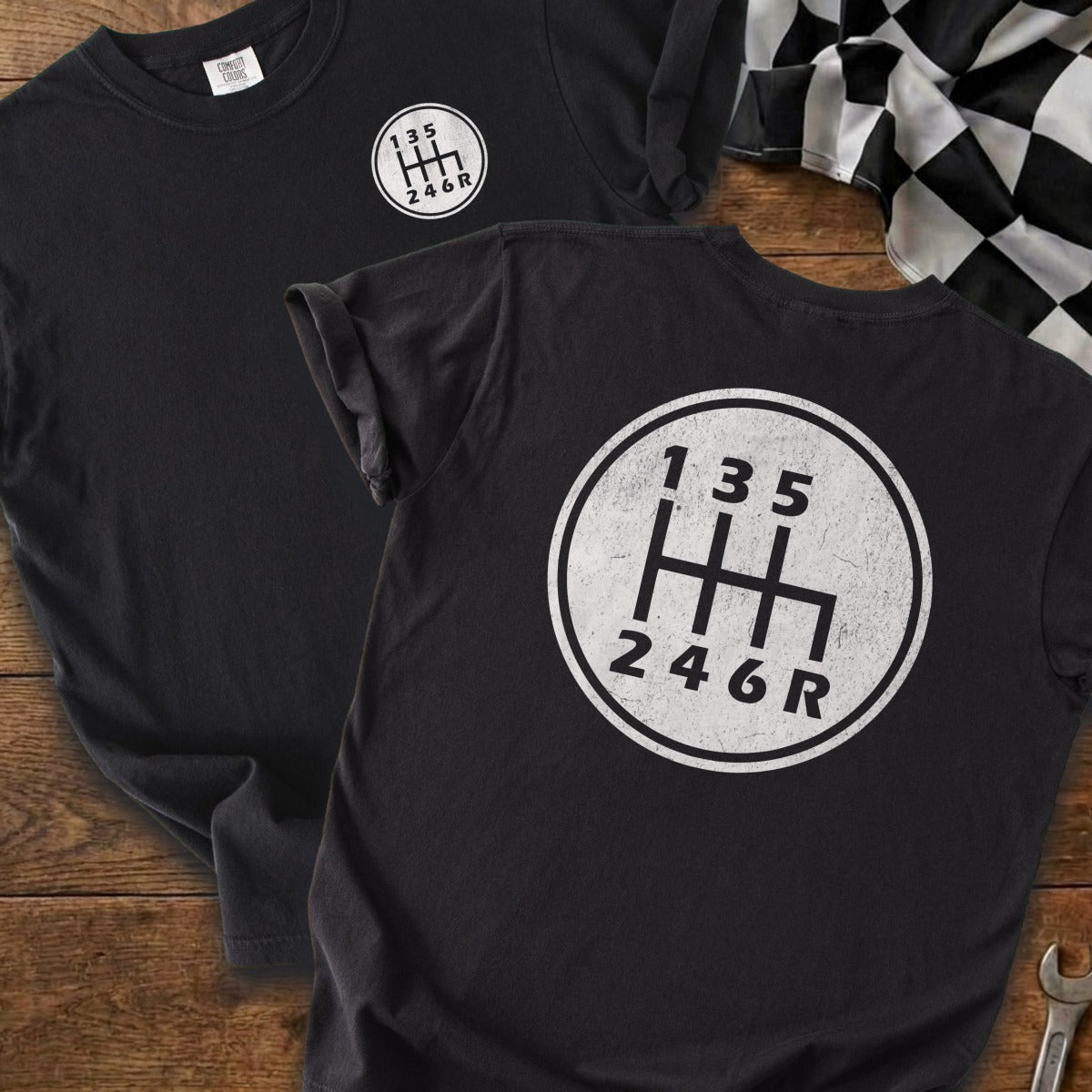 Black t-shirts with a white manual gear shift pattern graphic and numbers 1-6 and R.