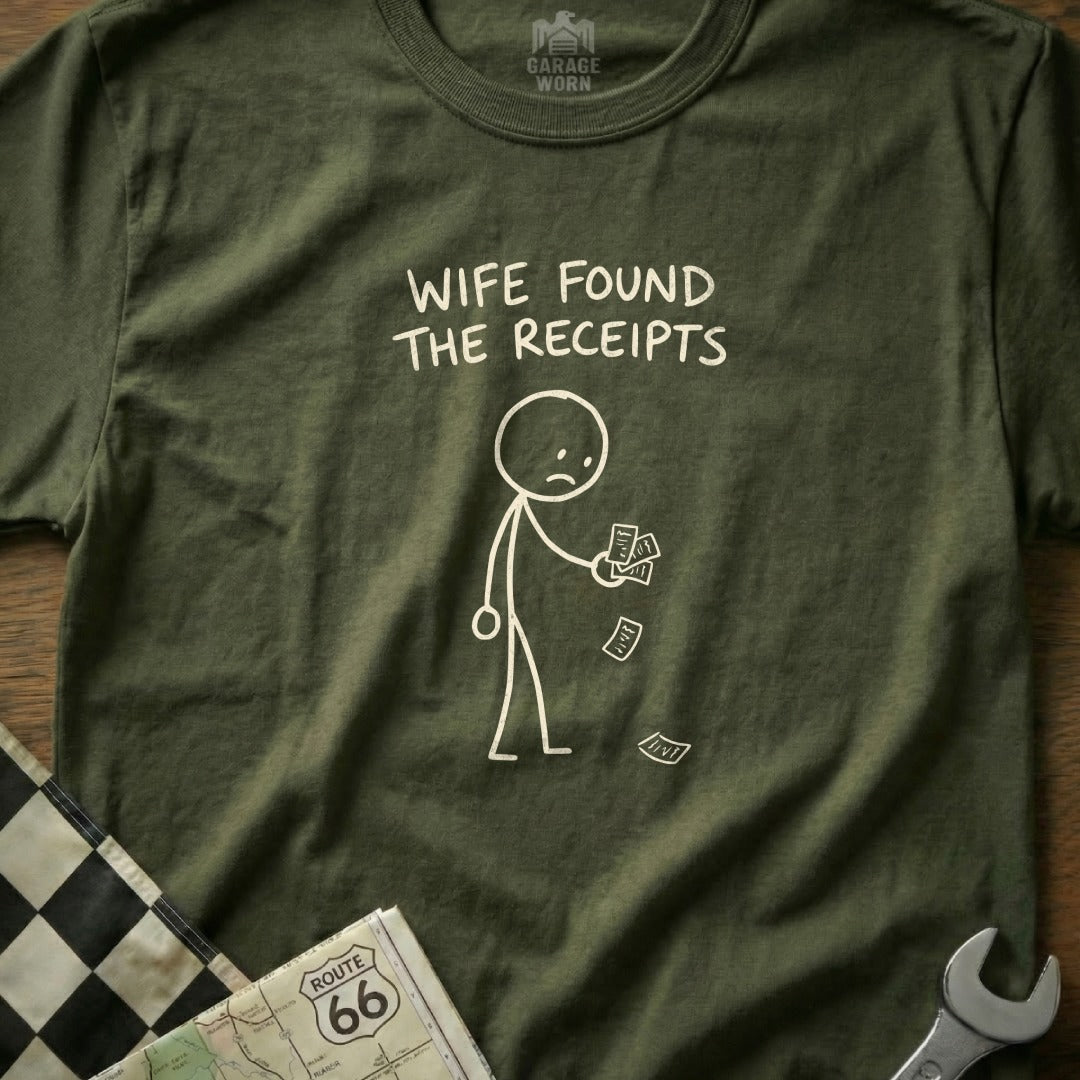 Olive green t-shirt with a stick figure holding receipts and the text "WIFE FOUND THE RECEIPTS".