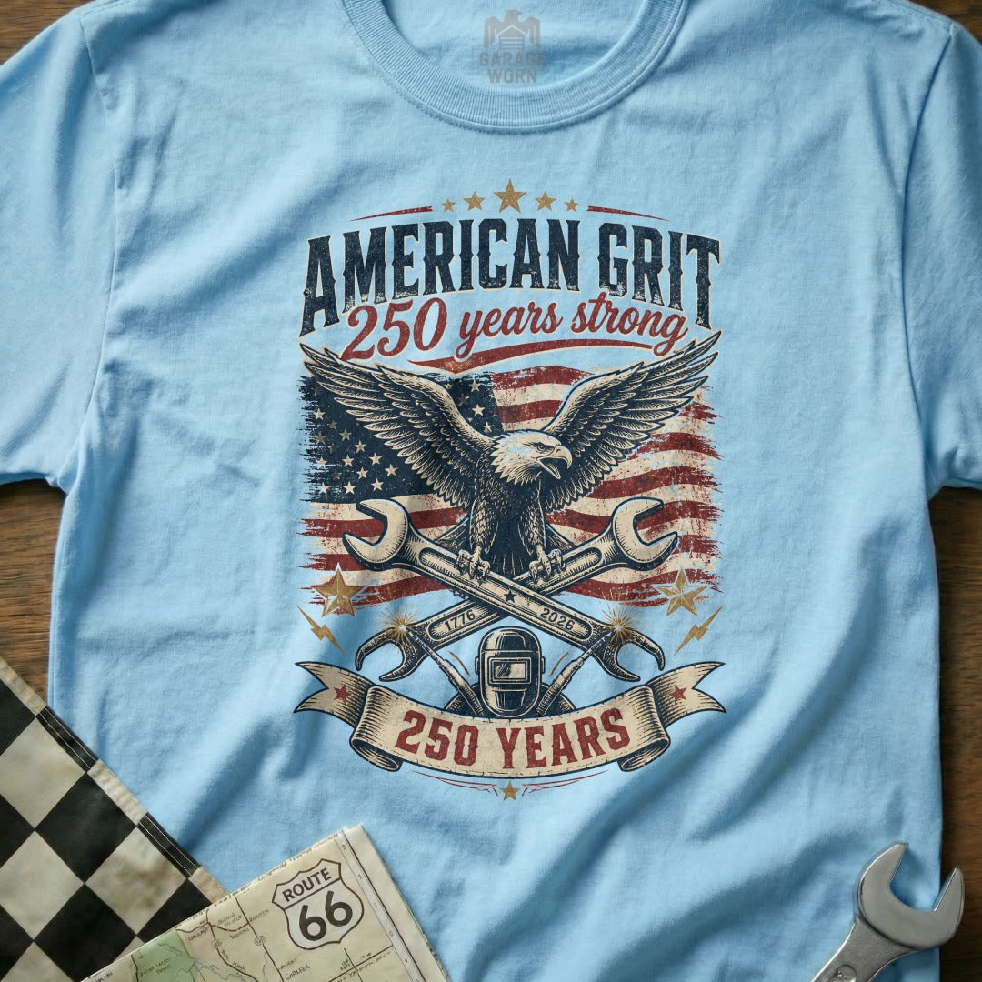 Light blue t-shirt with American eagle, wrenches, and "American Grit 250 Years Strong" text.