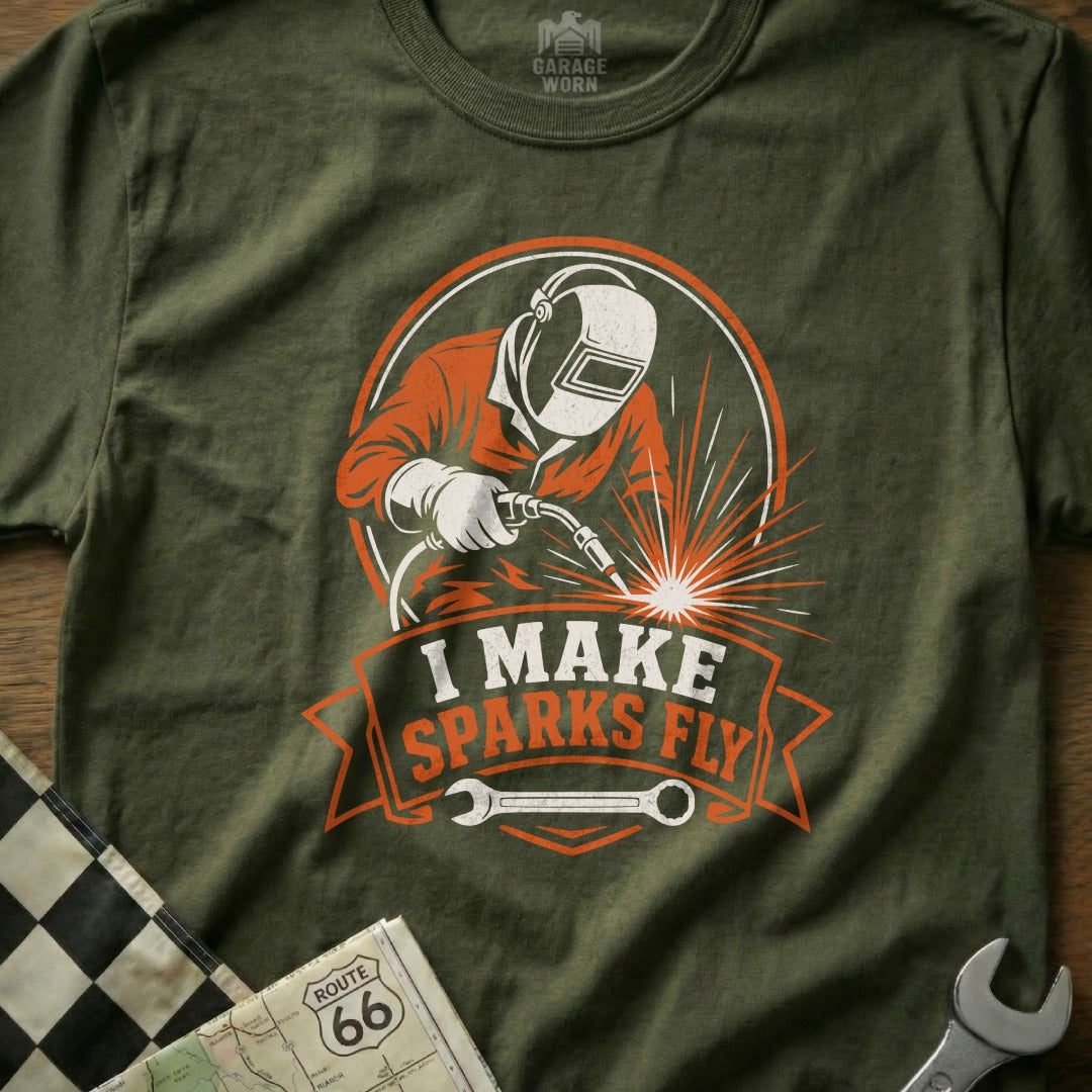Green t-shirt with welder graphic and text "I MAKE SPARKS FLY"