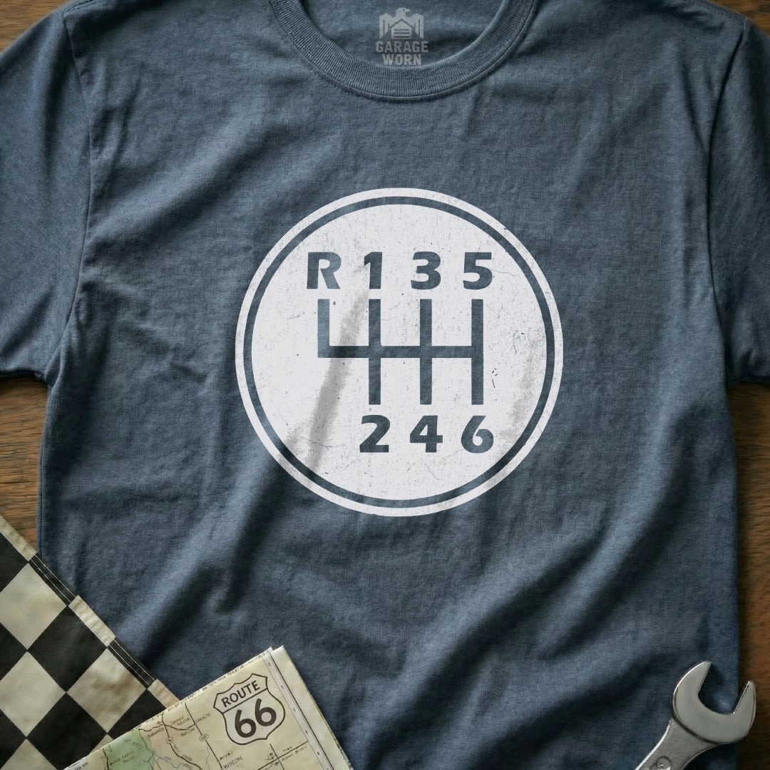 T-shirt with a white circle graphic of a six-speed manual transmission shift pattern.