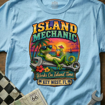 Light blue t-shirt with "Island Mechanic" art featuring a gecko relaxing on a wrench.