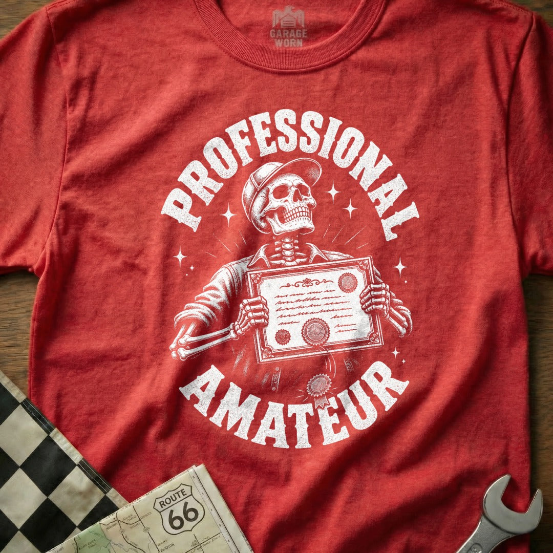 Red t-shirt with skeleton holding a certificate, wearing a hat. Text: Professional. Amateur.