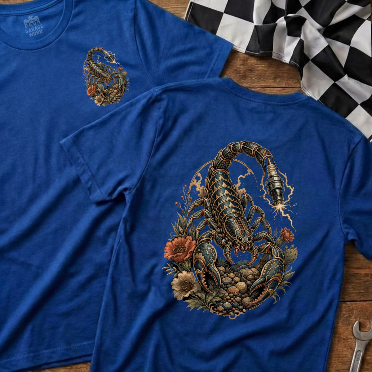 Blue t-shirt with detailed scorpion and spark plug graphic, surrounded by flowers.