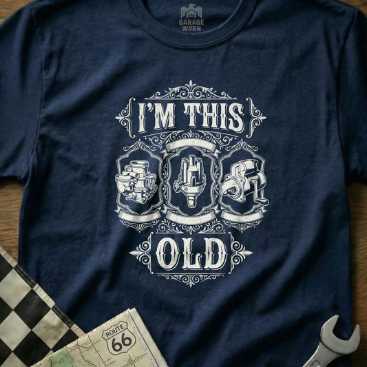 T-shirt with "I'M THIS OLD" and vintage car engine parts.