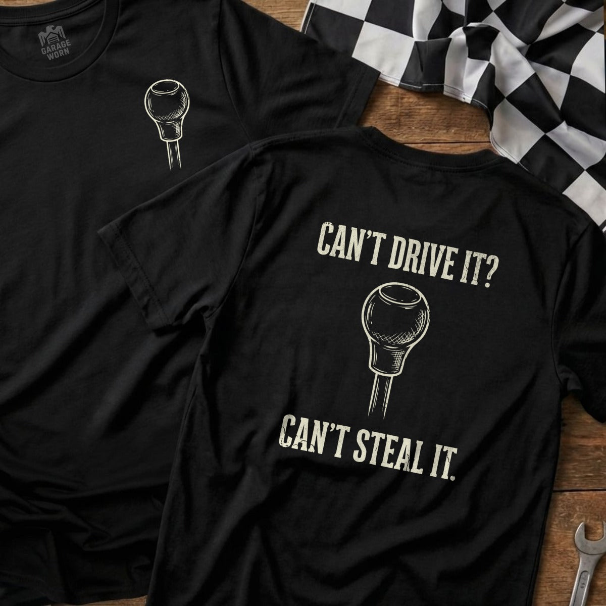 Black t-shirt with gear shift graphic and text "Can't Drive It? Can't Steal It."