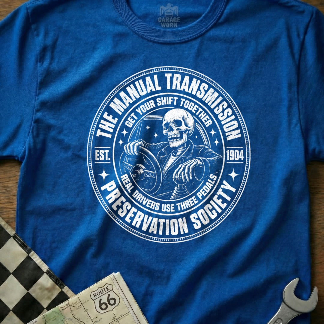 Skeleton driving manual transmission, "The Manual Transmission Preservation Society" text.