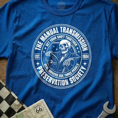 Skeleton driving manual transmission, "The Manual Transmission Preservation Society" text.