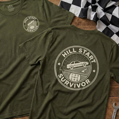 Olive green t-shirt with "Hill Start Survivor" text and truck graphic on circular emblem.