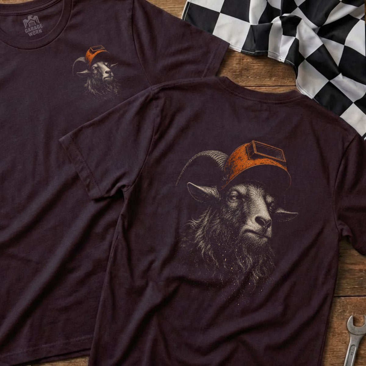 Dark t-shirt featuring a ram wearing a welding helmet, with logo on chest.