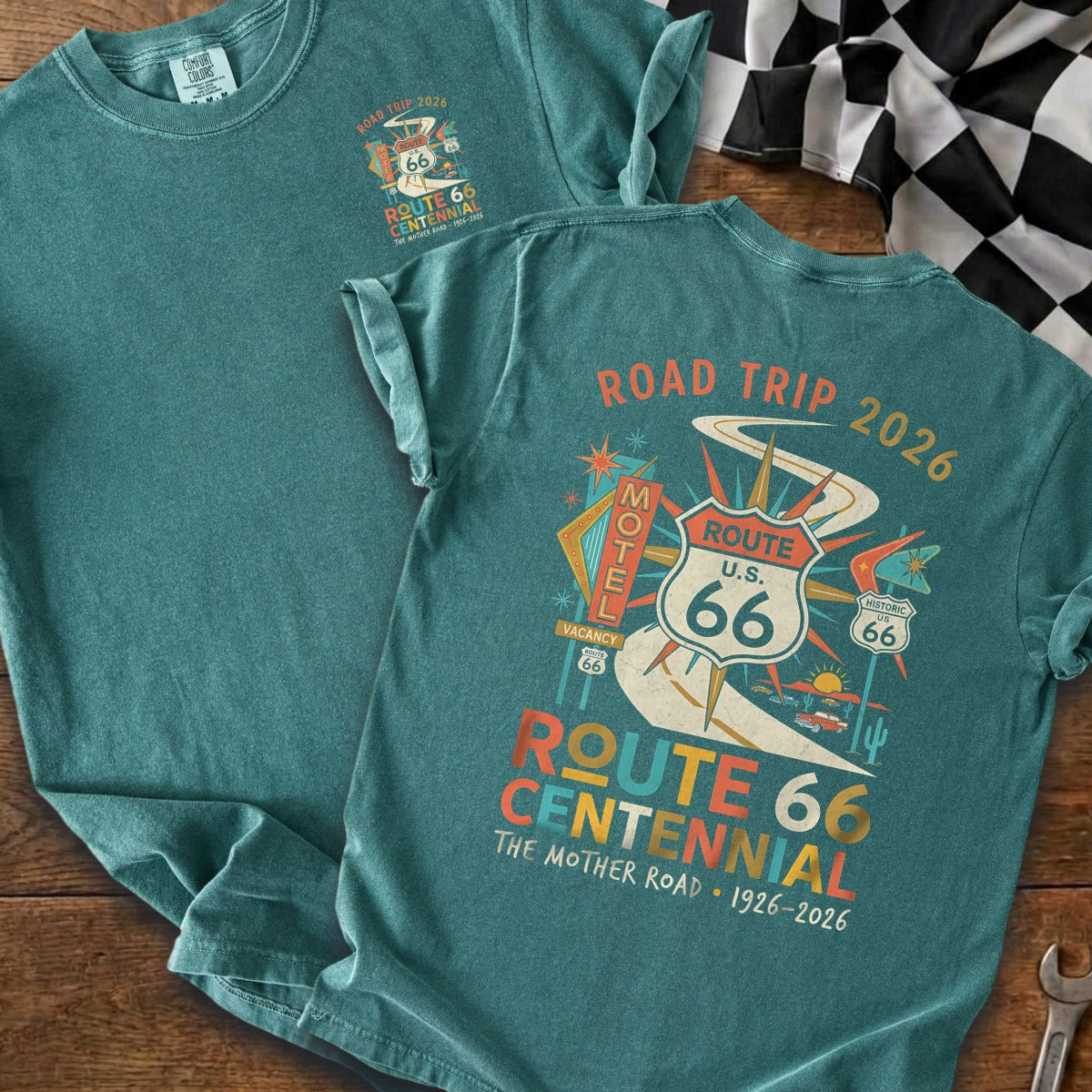 Teal t-shirt with Route 66 Centennial graphic featuring motel, cars, and road.