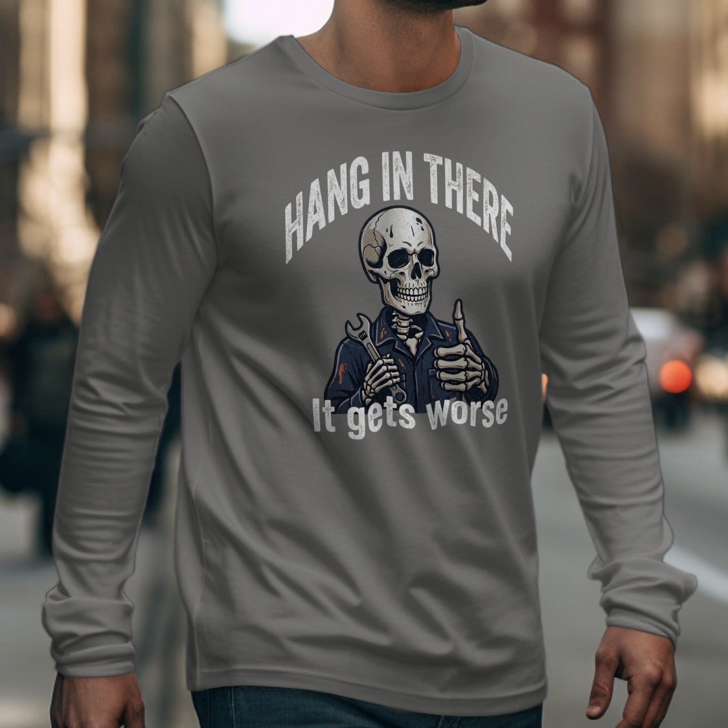 Long sleeve shirt with skeleton giving thumbs up and text "Hang In There It Gets Worse".