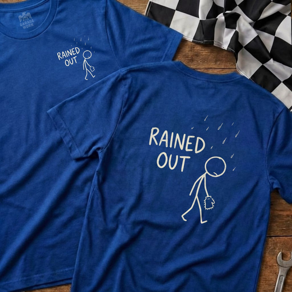 Two blue t-shirts with stick figure and "Rained Out" text.