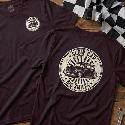 Dark t-shirt with circular "Slow Car Big Smiles" graphic featuring a vintage Volkswagen Beetle.