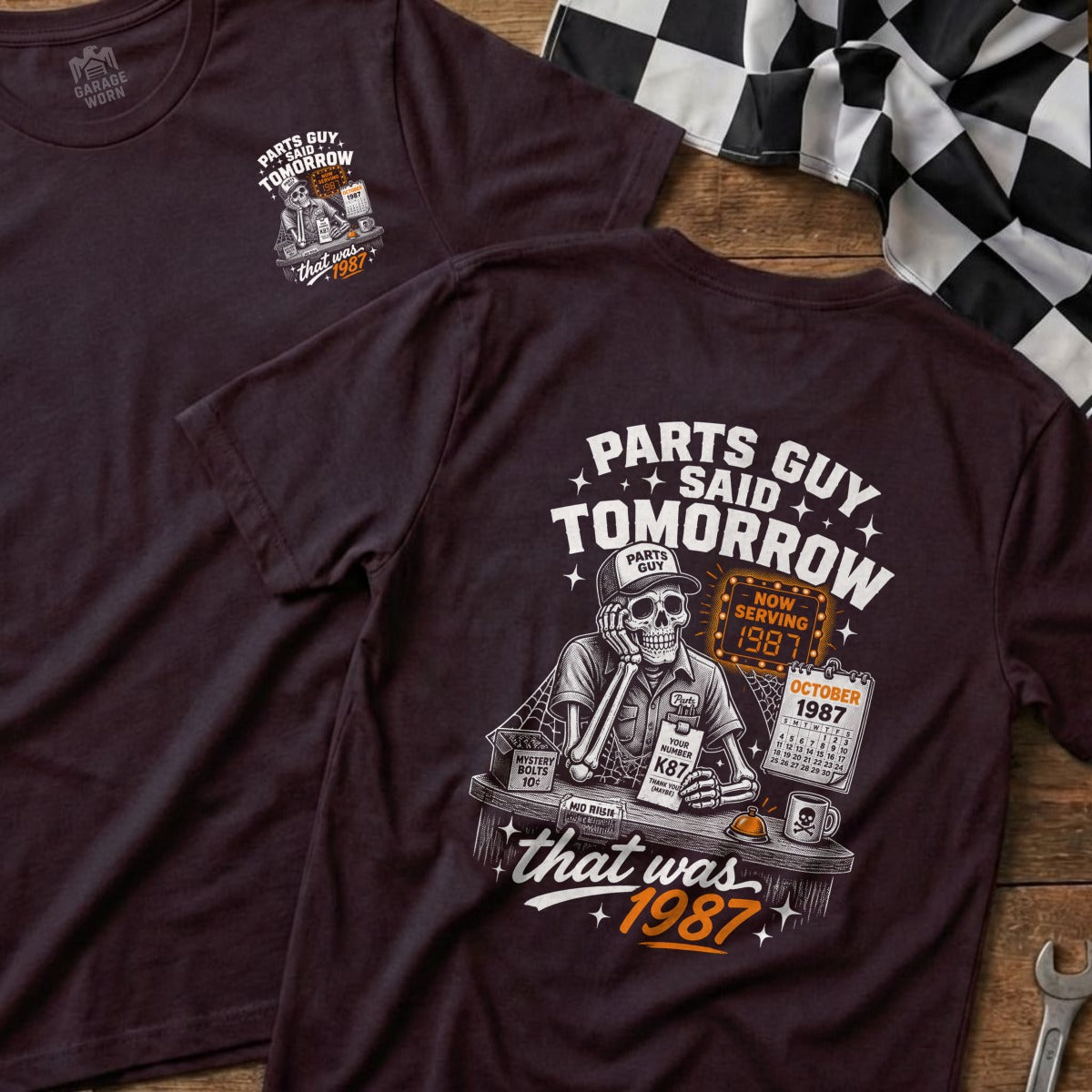 Dark t-shirt graphic with skeleton, calendar, and text "Parts Guy Said Tomorrow".