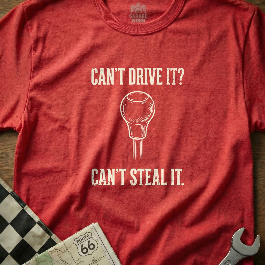 Red t-shirt with "Can't Drive It? Can't Steal It." and a gear shift knob.