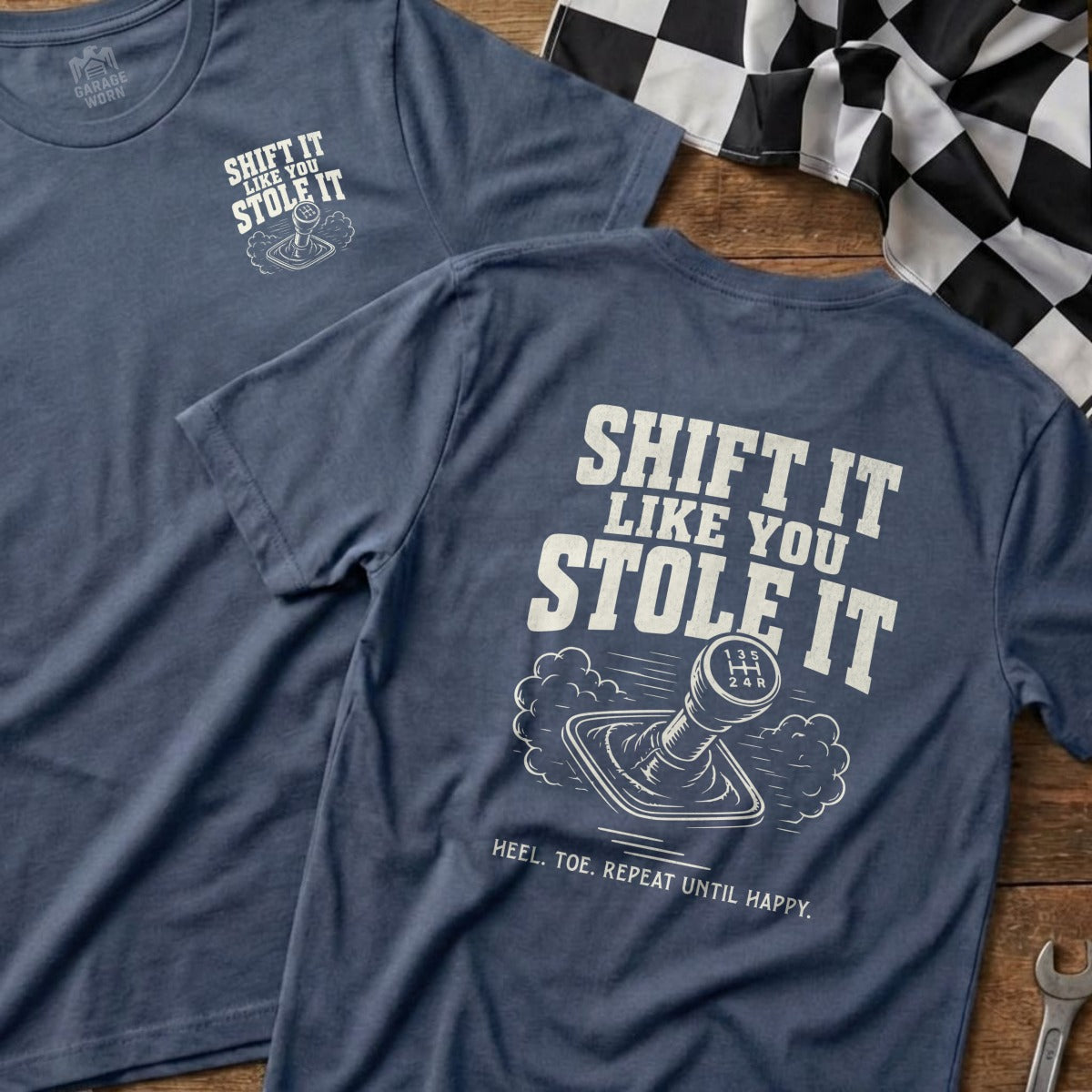 Blue t-shirt with "Shift It Like You Stole It" and gear shift graphic.