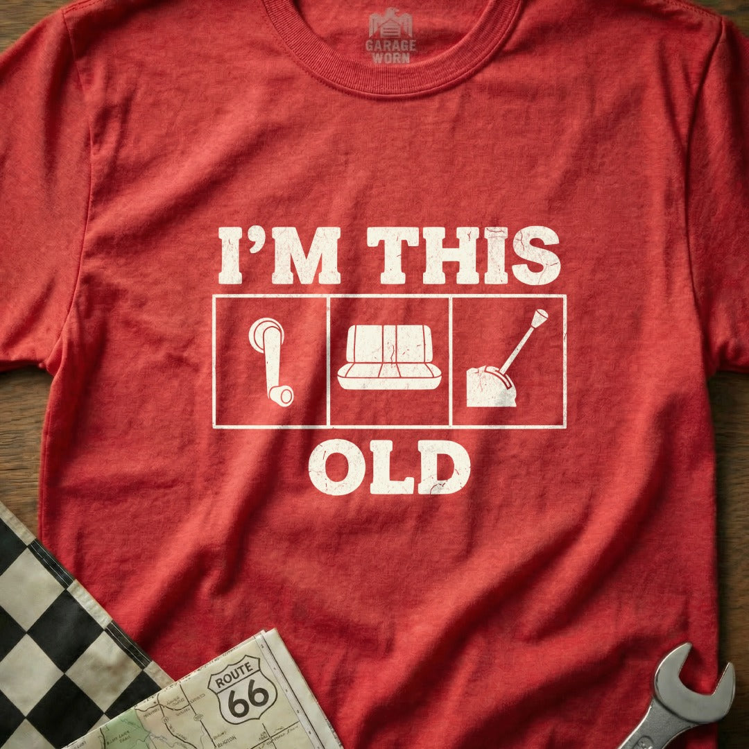 Red t-shirt with "I'M THIS OLD" and icons of a gear stick, cassette tape, and dial.