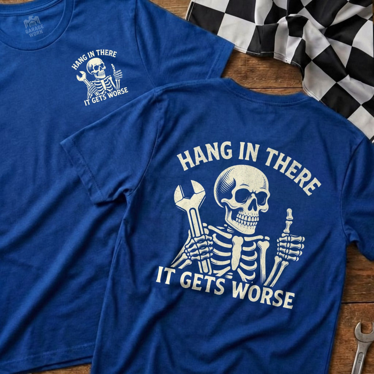 Blue t-shirt with a skeleton holding a wrench and text "Hang in There It Gets Worse".
