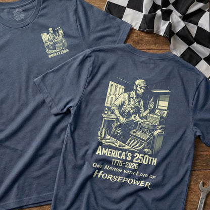 Blue t-shirt with graphic of mechanic and text "America's 250th One Nation with Lots of Horsepower".