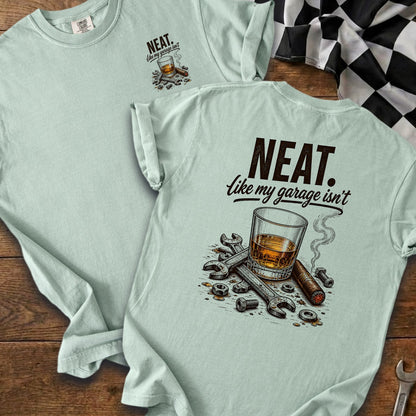 Light blue t-shirt with "NEAT. like my garage isn't" and glass, cigar, tools graphic.