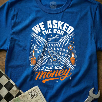 Skeleton hands on a blue shirt around a wrench, with text "WE ASKED THE CAR it just said Money".