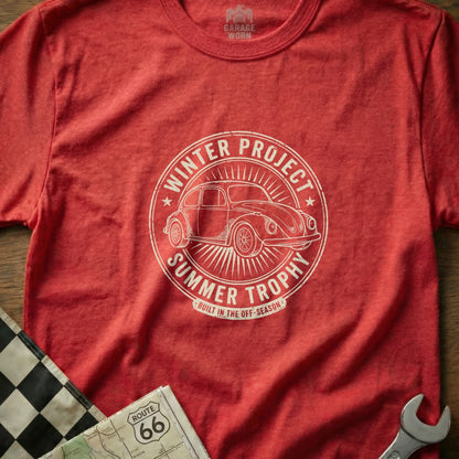Red t-shirt with a white circular graphic of a Volkswagen Beetle, "Winter Project Summer Trophy" text.