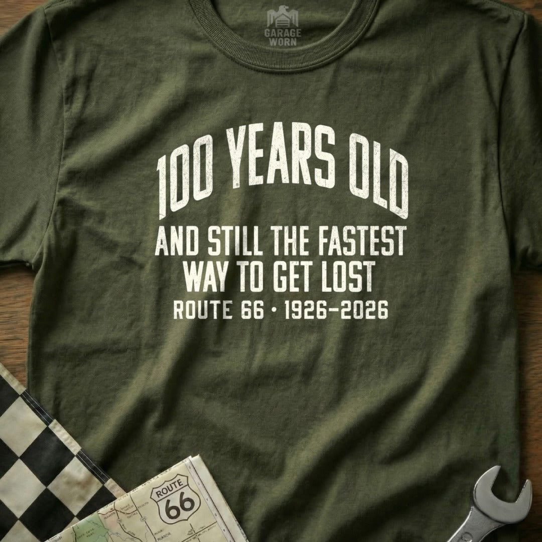 Olive t-shirt with "100 Years Old and Still the Fastest Way to Get Lost Route 66" text.