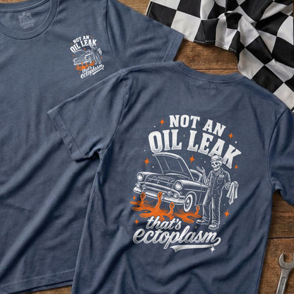 Blue t-shirt with graphic of skeleton mechanic and vintage car, text "NOT AN OIL LEAK that's ectoplasm".