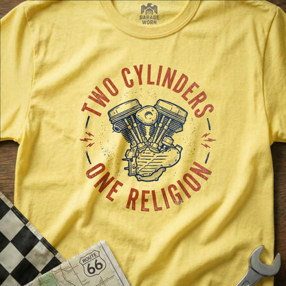 Yellow t-shirt with "TWO CYLINDERS ONE RELIGION" text and motorcycle engine graphic.