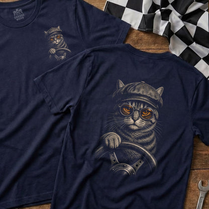 T-shirt design of a tabby cat wearing a cap and goggles, holding a steering wheel.
