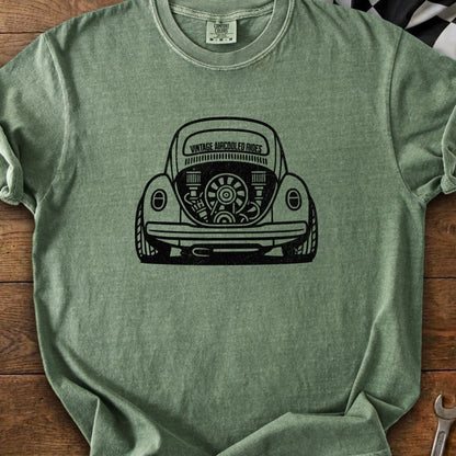 Green t-shirt with black graphic of a vintage Volkswagen Beetle's rear engine bay.