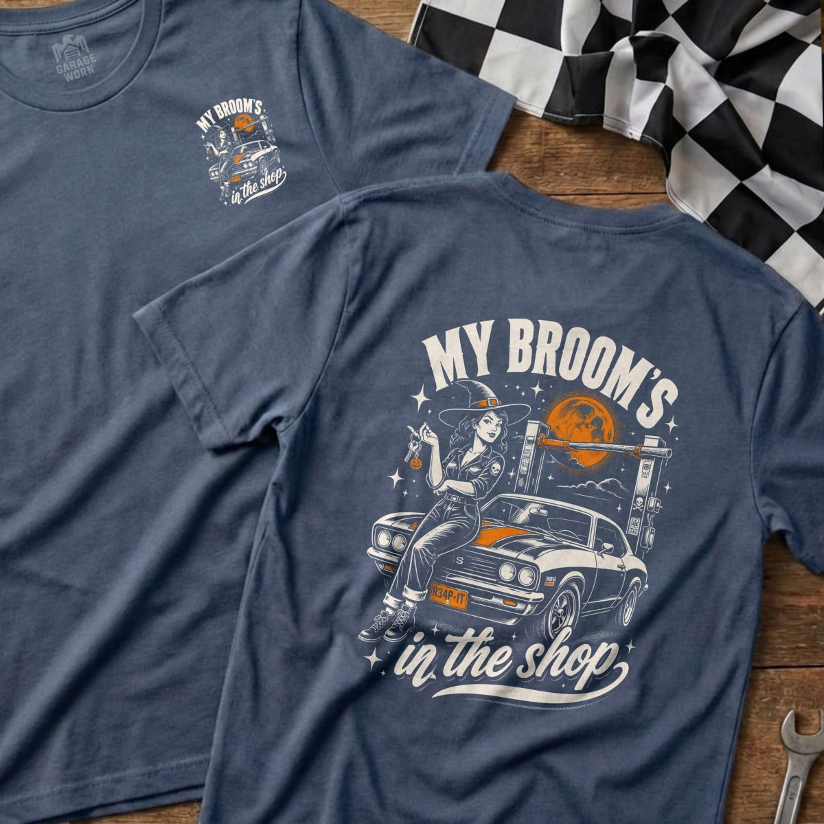T-shirt graphic with witch and car, reads "MY BROOM'S in the shop".
