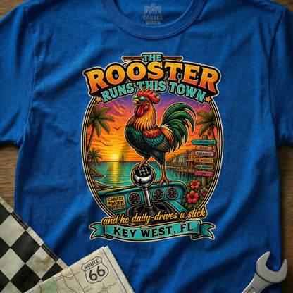 Rooster on a stick shift, "The Rooster Runs This Town" text, Key West scene.