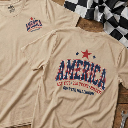 Tan t-shirts with "America" in red, white, and blue, celebrating 250 years.