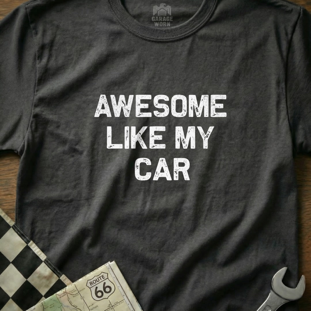 Dark t-shirt with white text "AWESOME LIKE MY CAR" and checkered flag.
