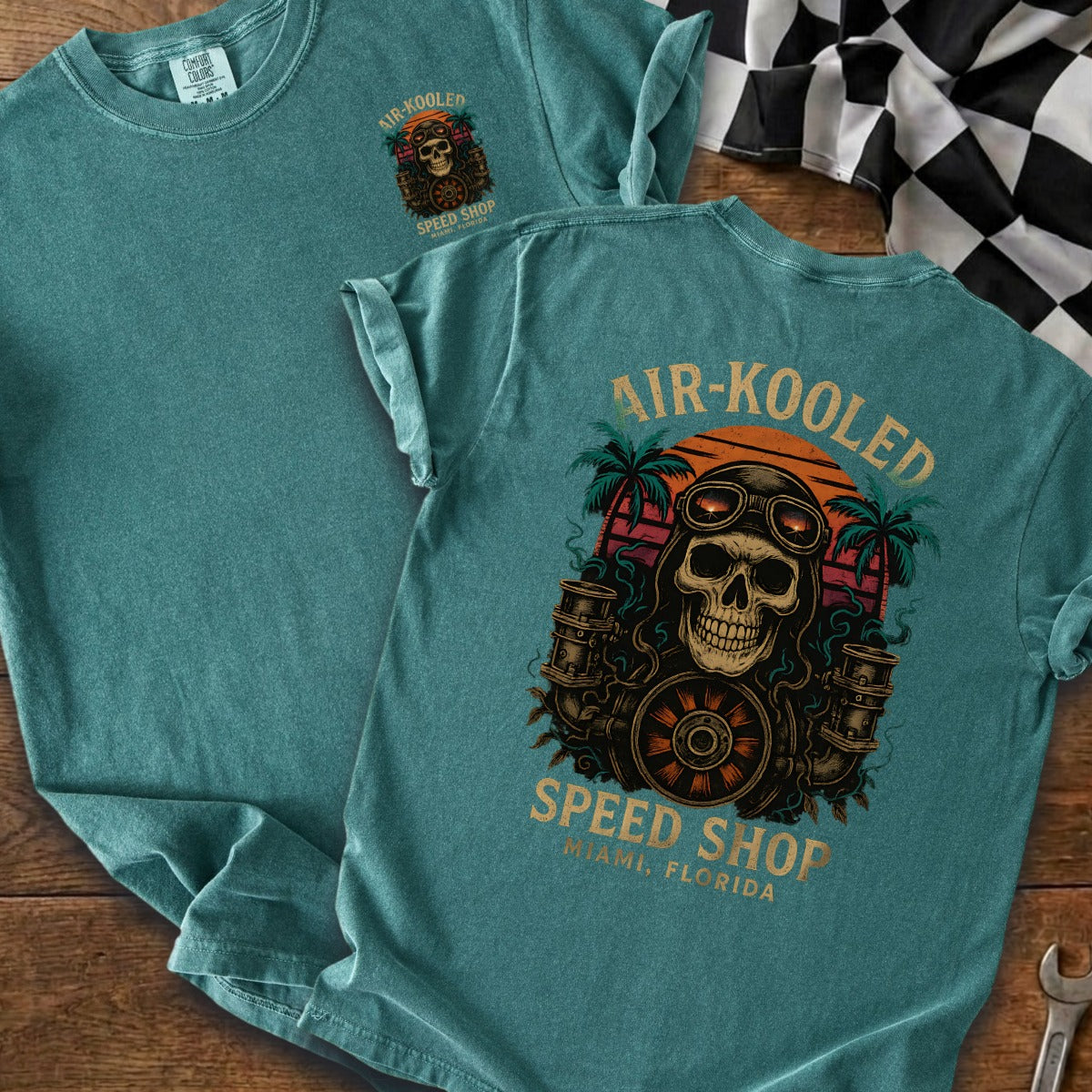 Teal t-shirt with Air-Kooled Speed Shop skull graphic, palm trees, and sunset.