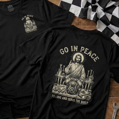 T-shirt with Jesus working on an engine, "Go In Peace To Love And Serve The Build."